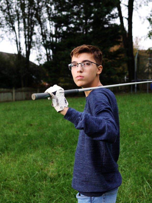 Luc Esquivel holding golf club.