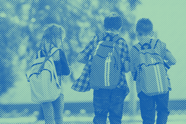 3 Children with backpacks walking home from school