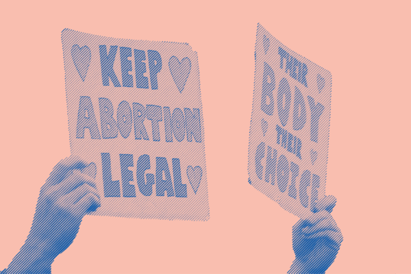 Two signs are being held at a protest. The first sign says "Keep Abortion Legal". The second sign says "Their Body Their Choice"