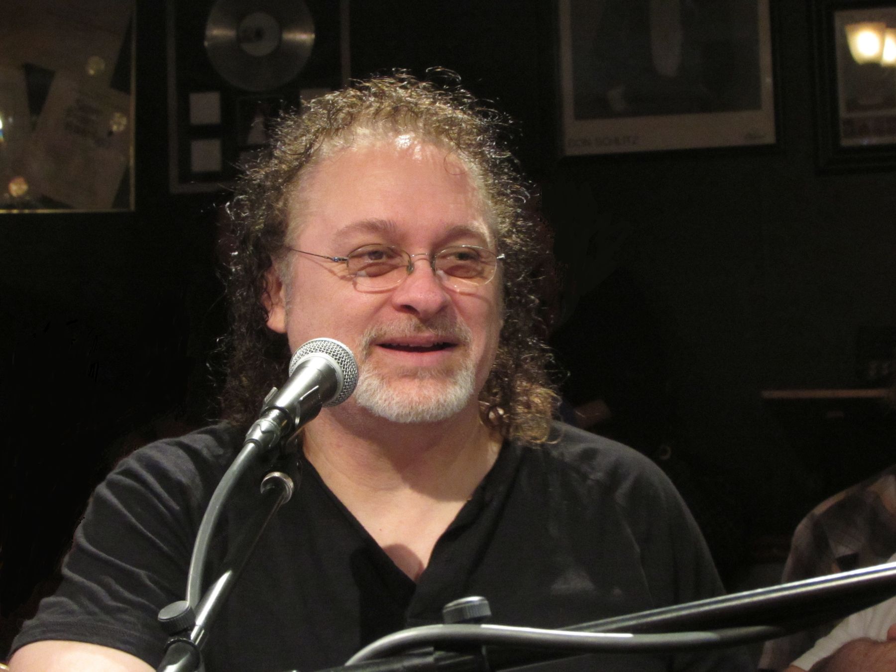 Don Henry in front of a microphone.