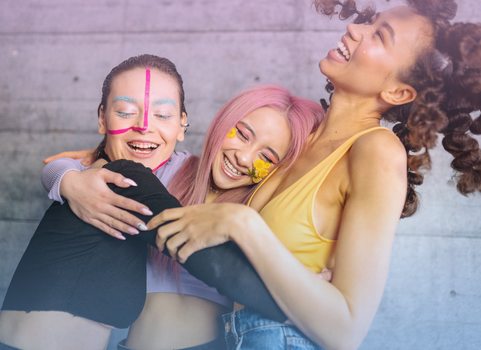 Group of LGBTQ+ people smiling with trans color facepaint