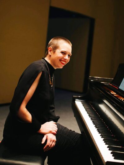 Maeve Brophy sits at a piano.