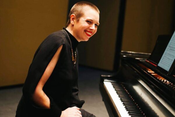 Maeve Brophy sits at a piano.