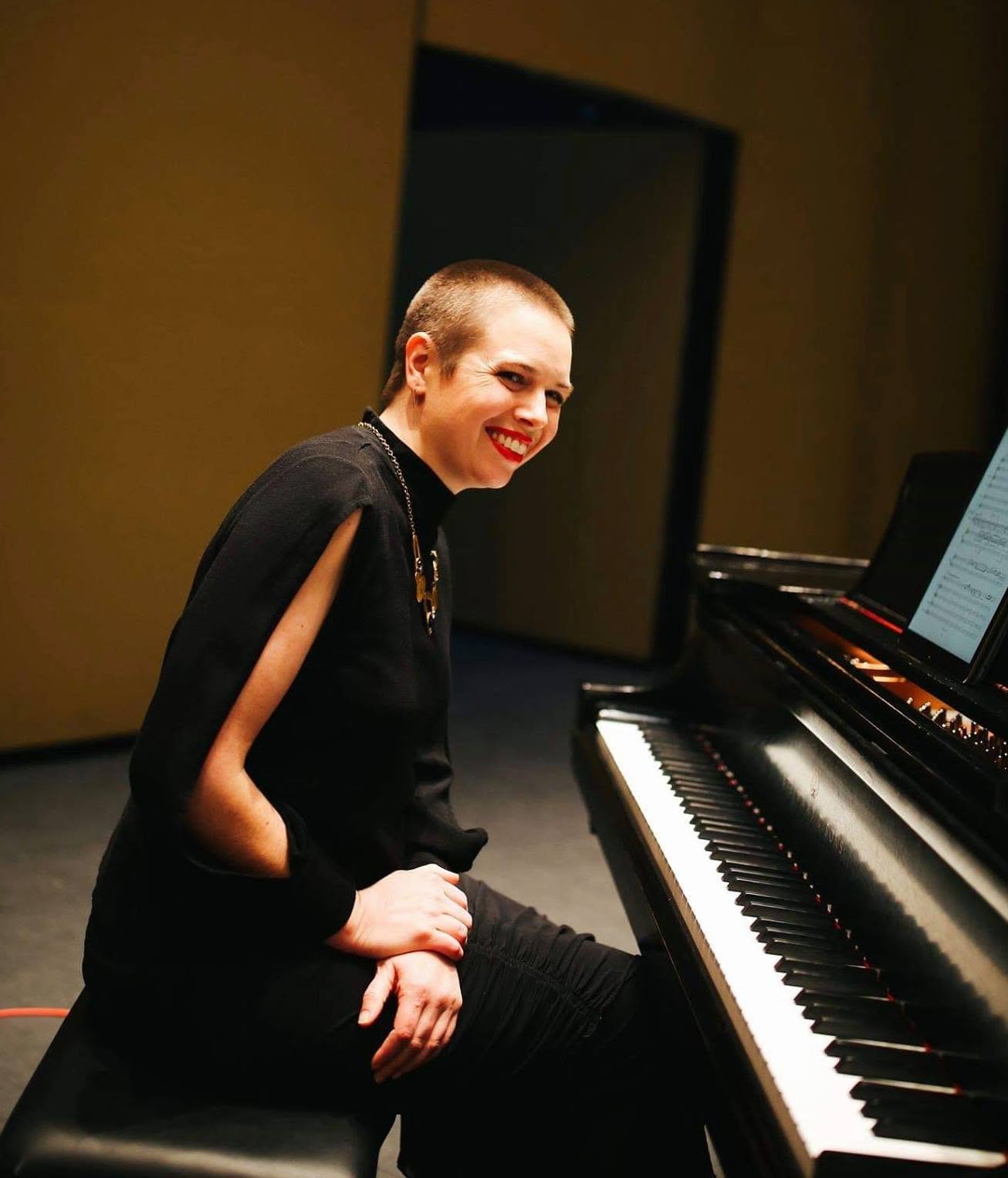 Maeve Brophy sits at a piano.