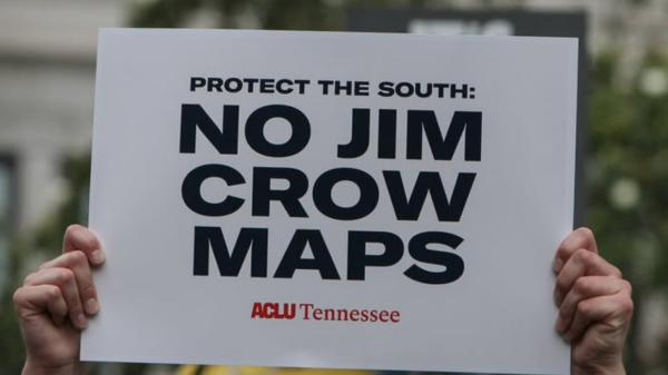 Person holding a sign that says No Jim Crow Maps.