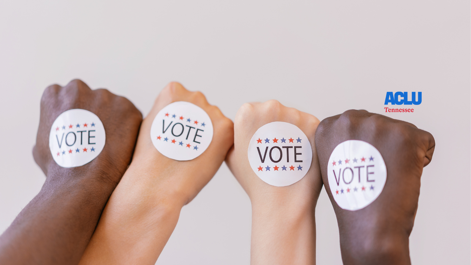 Four different fists with "Vote" stickers on them.
