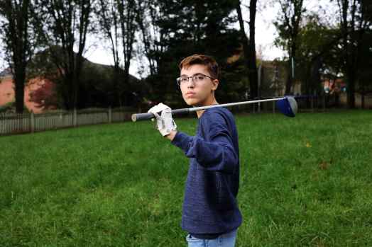 Luc Esquivel holding golf club.